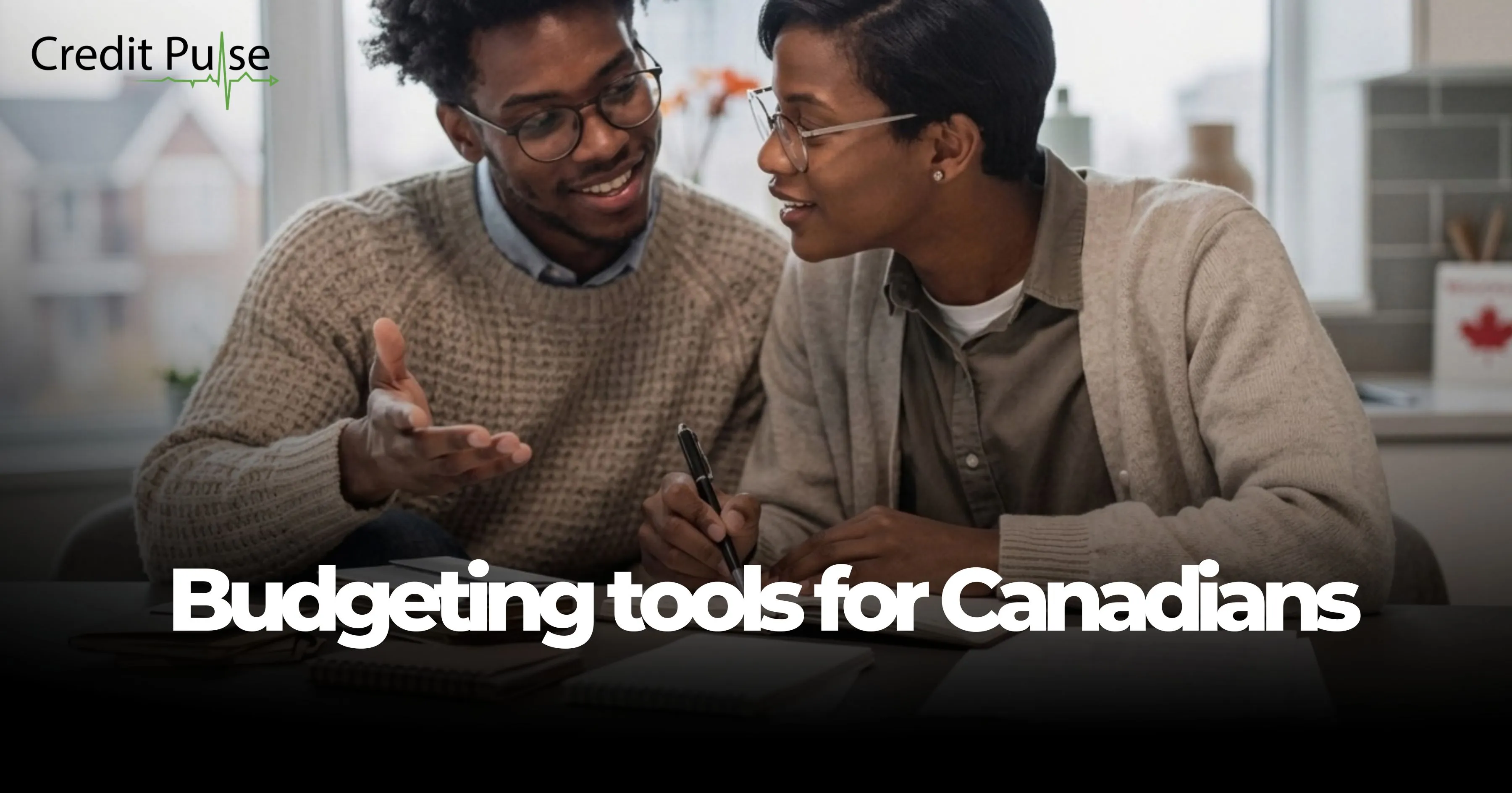 Two Canadians reviewing budgeting tools together at a kitchen table to manage household debt