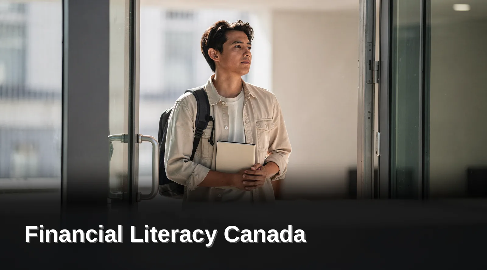 Young Canadian student holding a notebook while planning a monthly budget